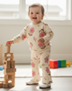 Child playing with wooden blocks in a bright room