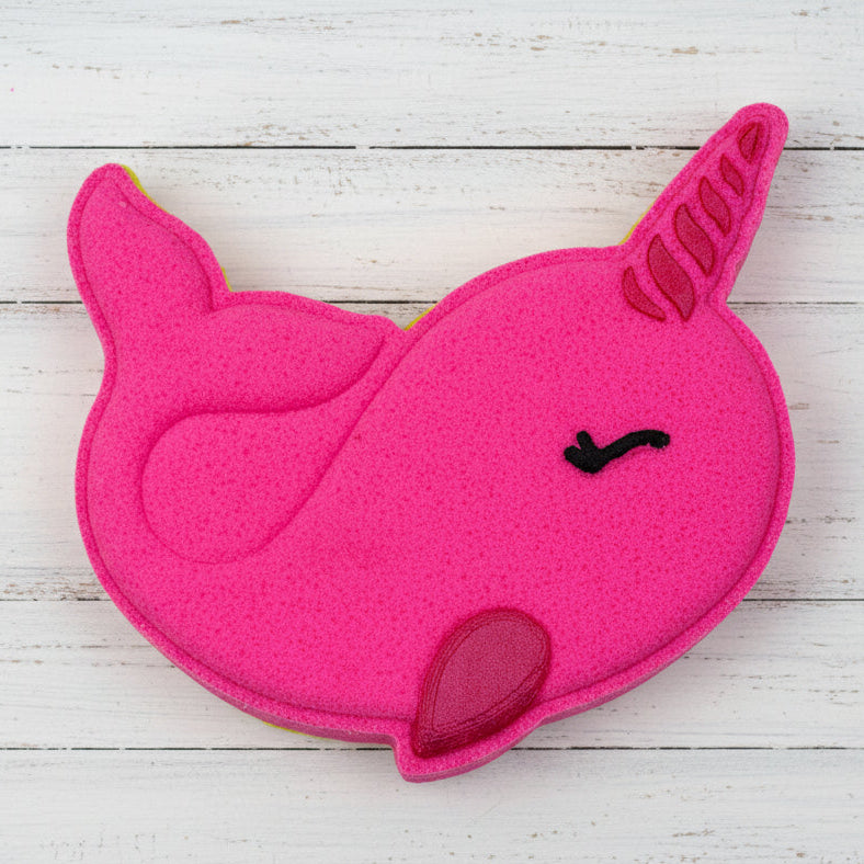 Pink unicorn-shaped object on pebbles