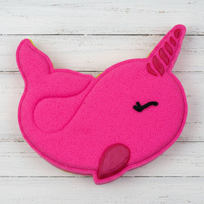 Pink unicorn-shaped object on pebbles