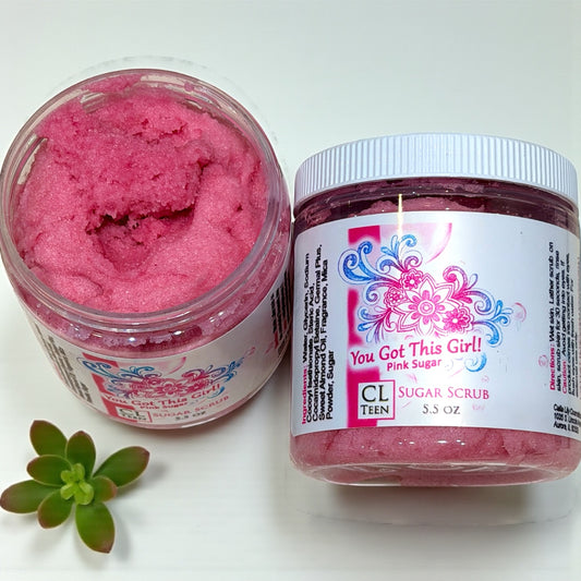 Pink sugar scrub in a jar with a decorative label on a white background