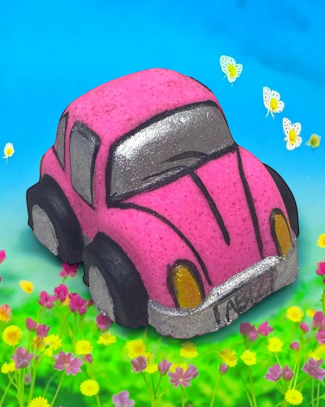 Pink bath bomb car with black tires on a colorful background with flowers and butterflies
