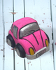 Pink and gray bath bomb car on a white wooden surface