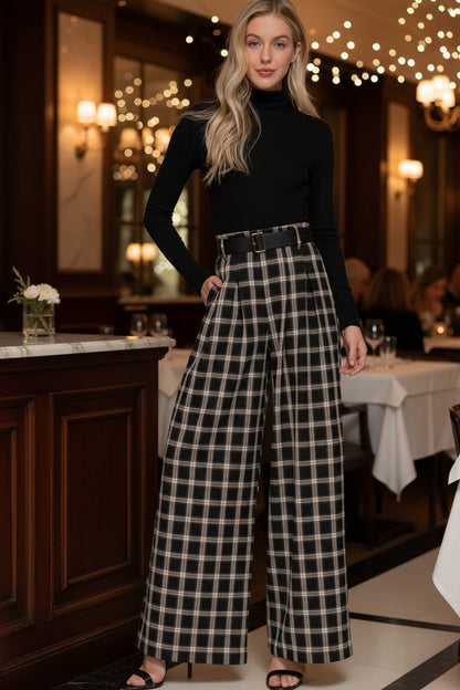 Woman wearing a black turtleneck and plaid pants on a white background