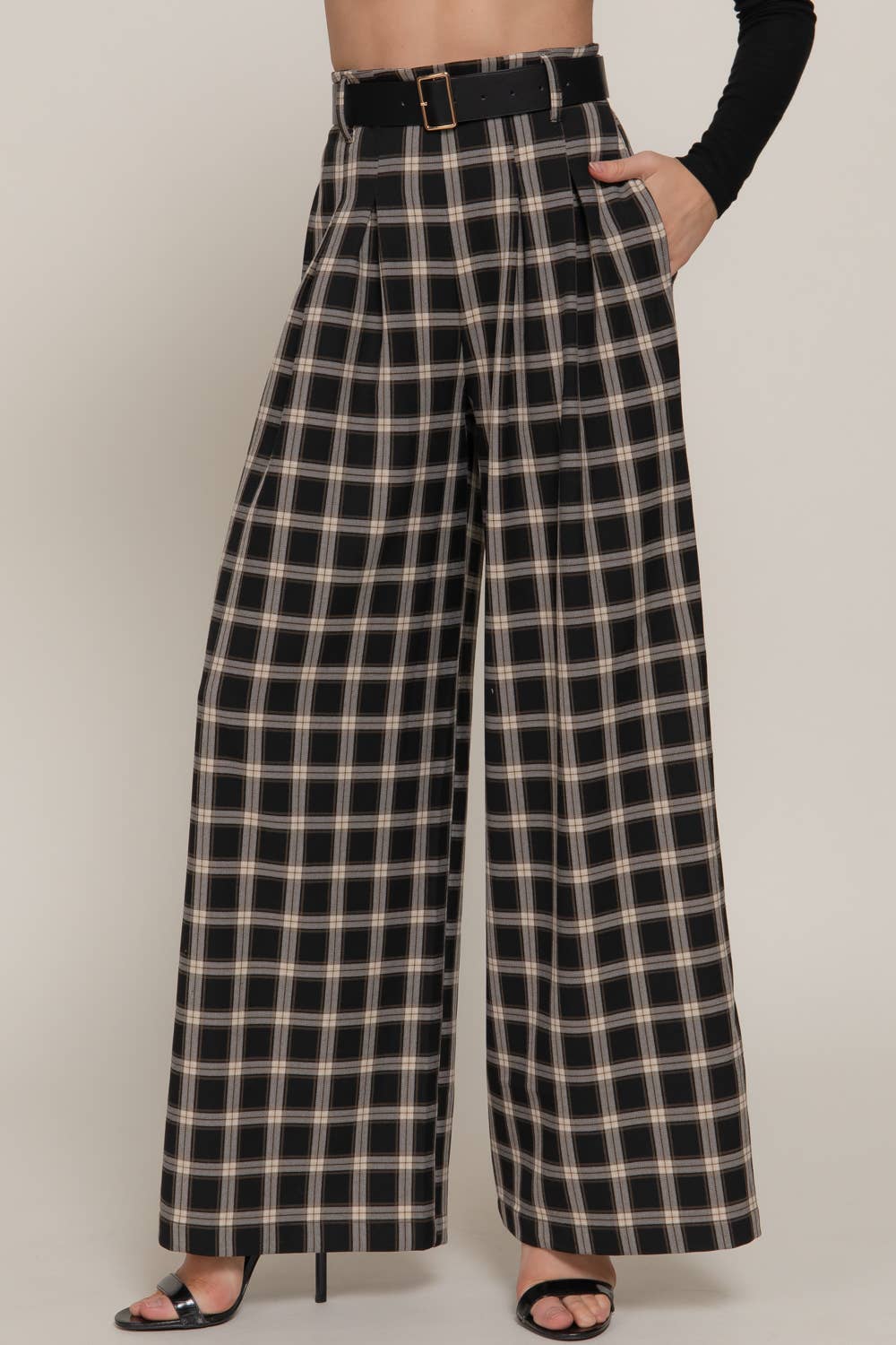 Plaid pants worn by a person on a plain background
