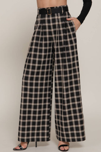Plaid pants worn by a person on a plain background