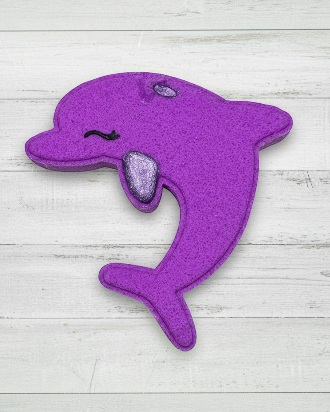 Purple dolphin-shaped toy on a white background
