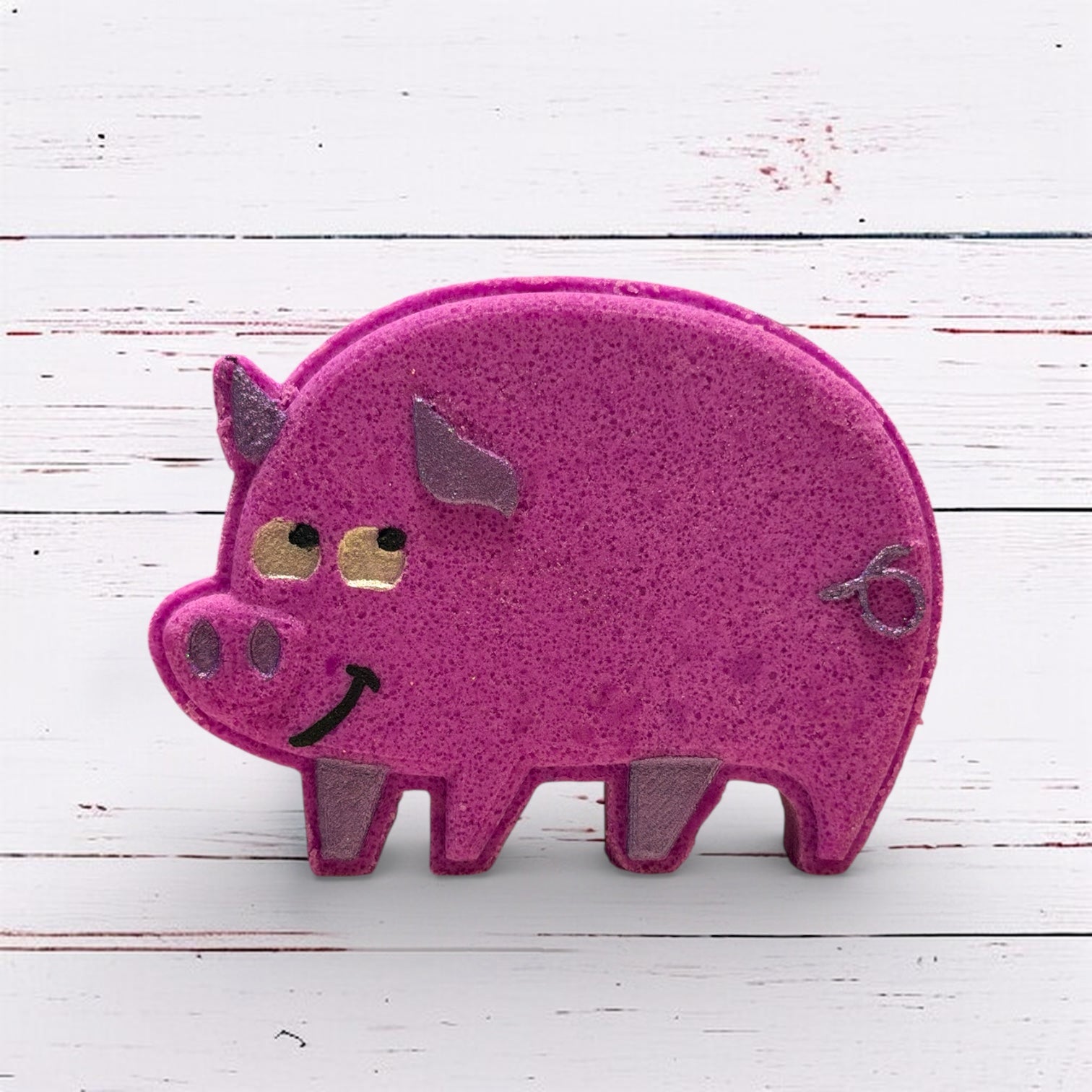 Purple  pig-shaped bath bomb on a white wooden background