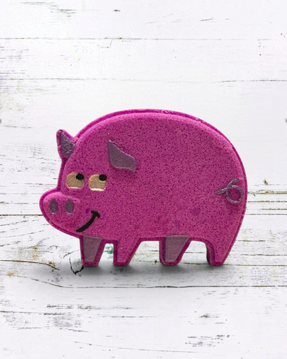 Purple  pig-shaped bath bomb on a white wooden background