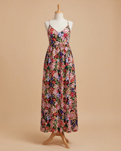 Woman wearing a colorful floral dress on a street.