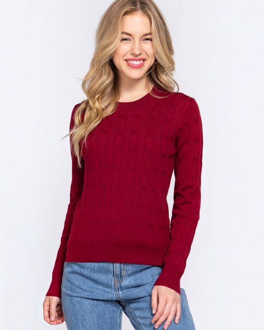 Woman wearing a red sweater and blue jeans on a white background