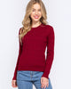 Woman wearing a red sweater and blue jeans on a white background