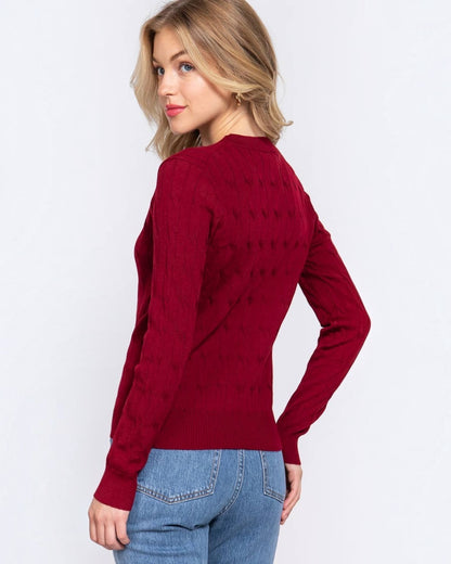 Woman wearing a red sweater and blue jeans on a white background