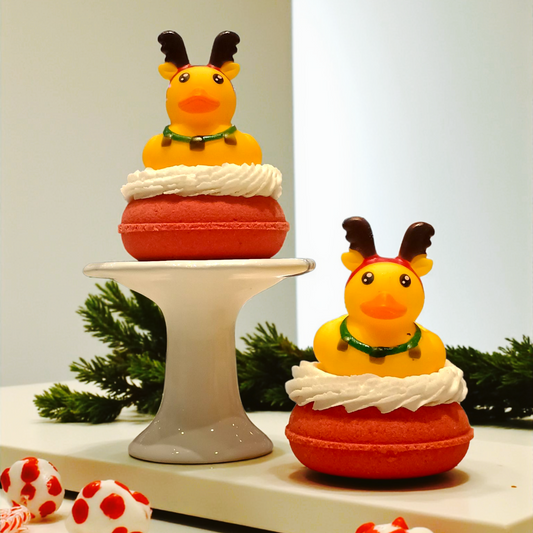 Two decorative duck figurines with antlers on a stand with a plain background