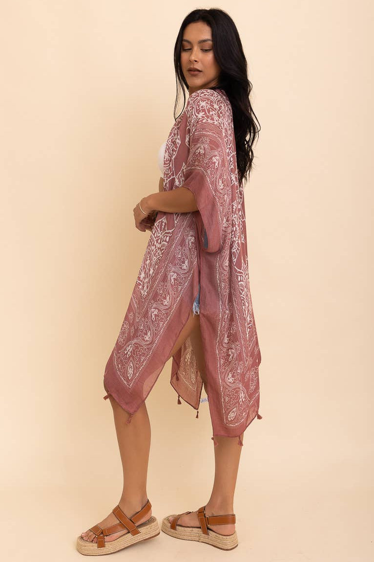 Woman wearing a pink lace dress against a beige background