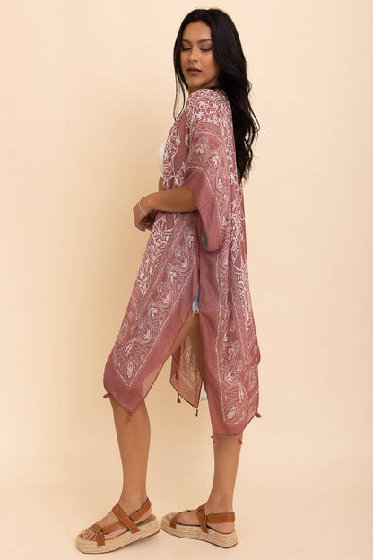 Woman wearing a pink lace dress against a beige background
