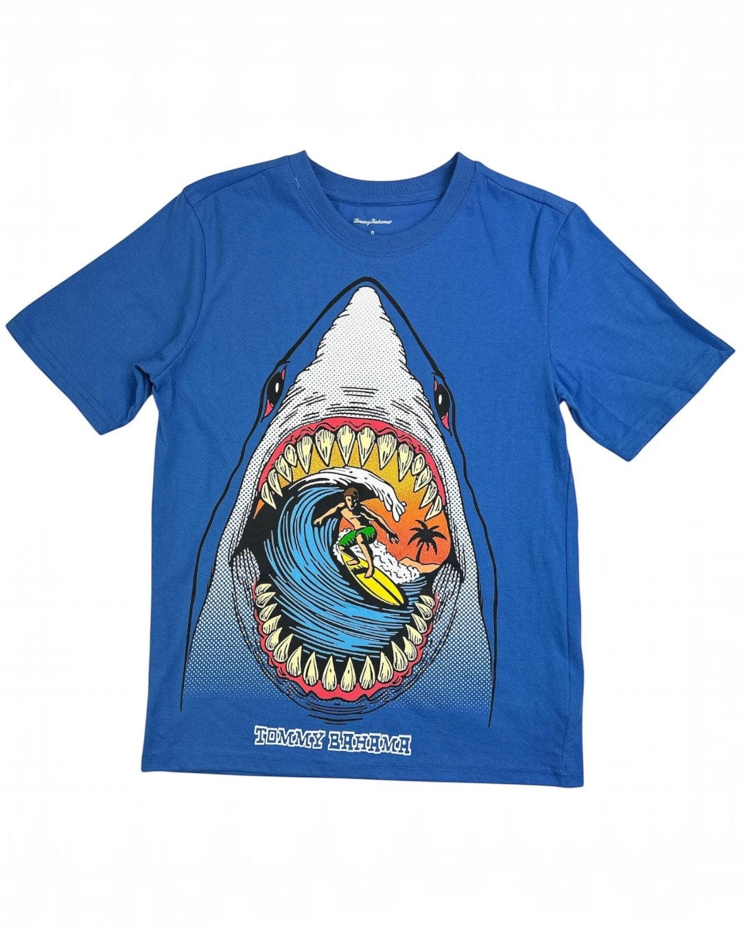 Blue t-shirt with a shark graphic featuring a surfer, on a white background