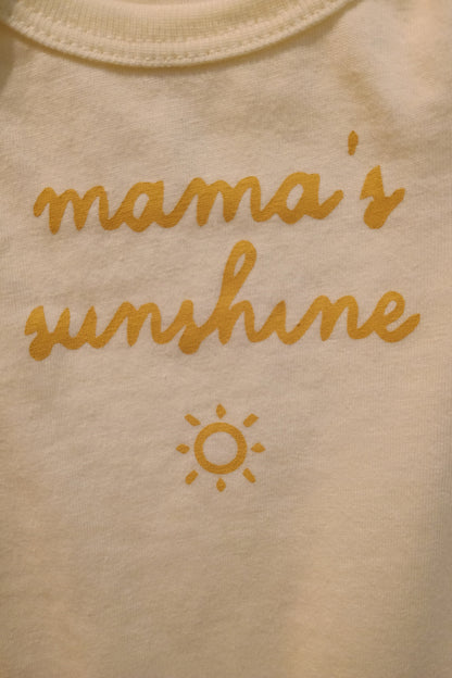 Light yellow fabric with 'mama's sunshine' text and sun symbol in yellow.