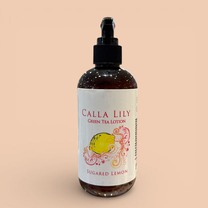 Bottle of Calla Lily Green Tea Lotion with a sugared lemon design on a beige background