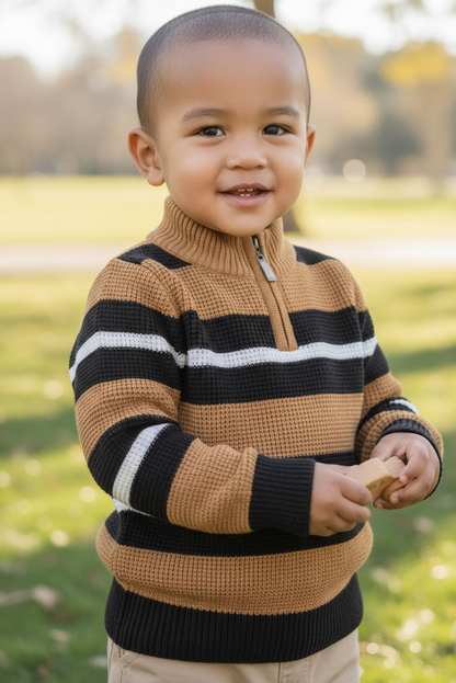 Child wearing a striped sweater outdoors in a park