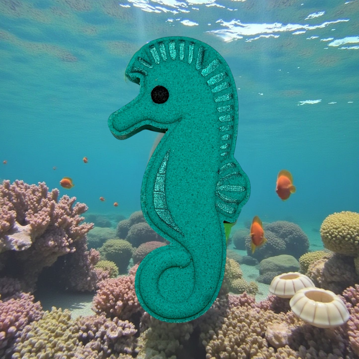 Green seahorse toy in an underwater scene with coral and fish