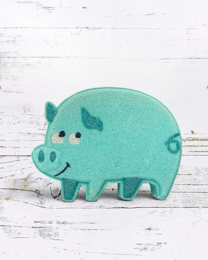 Teal pig-shaped bath toy on a white wooden background
