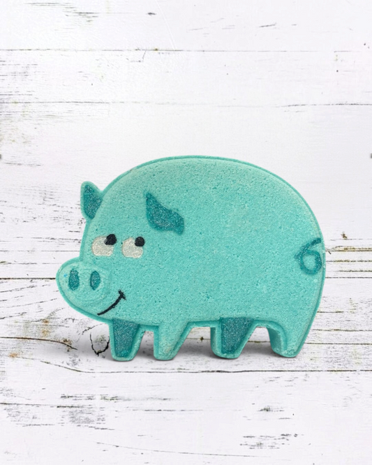 Teal pig-shaped bath toy on a white wooden background