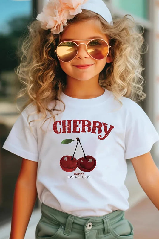 Child wearing a white t-shirt with cherry design and sunglasses outdoors