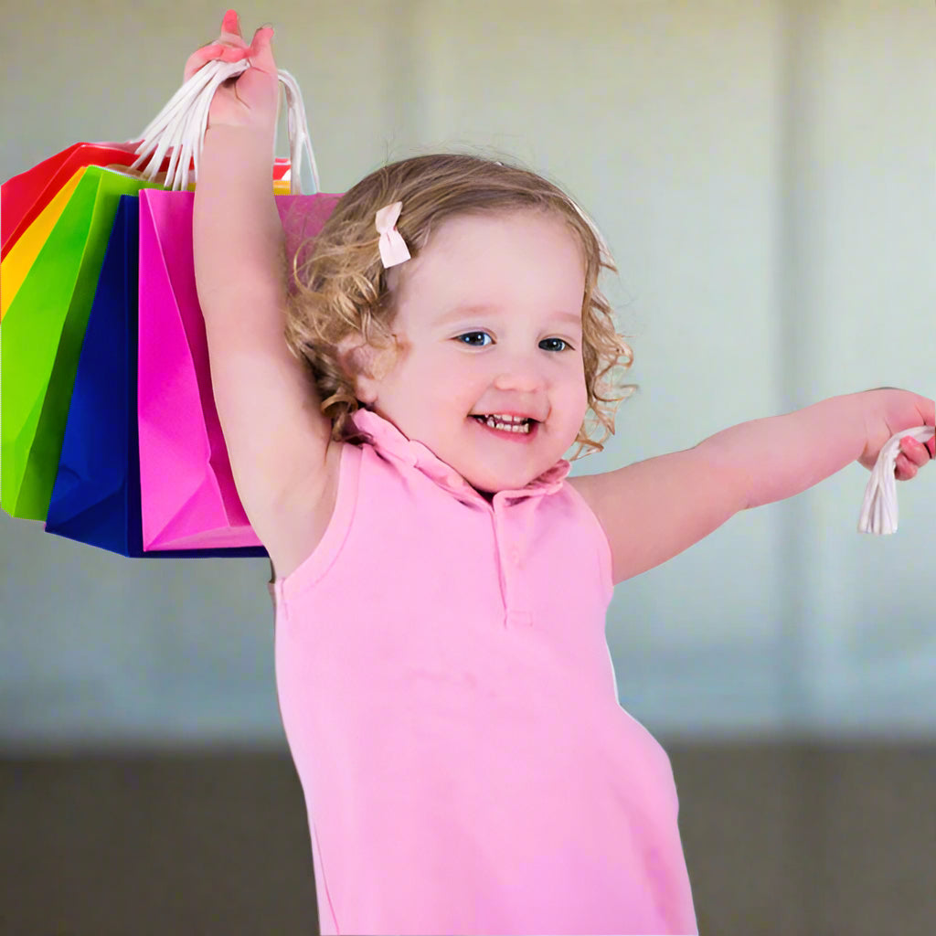 Child holding colorful shopping bags on a white background