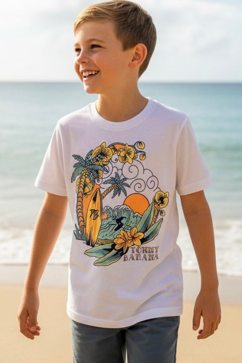 Child wearing a white t-shirt with a colorful graphic design on a beach