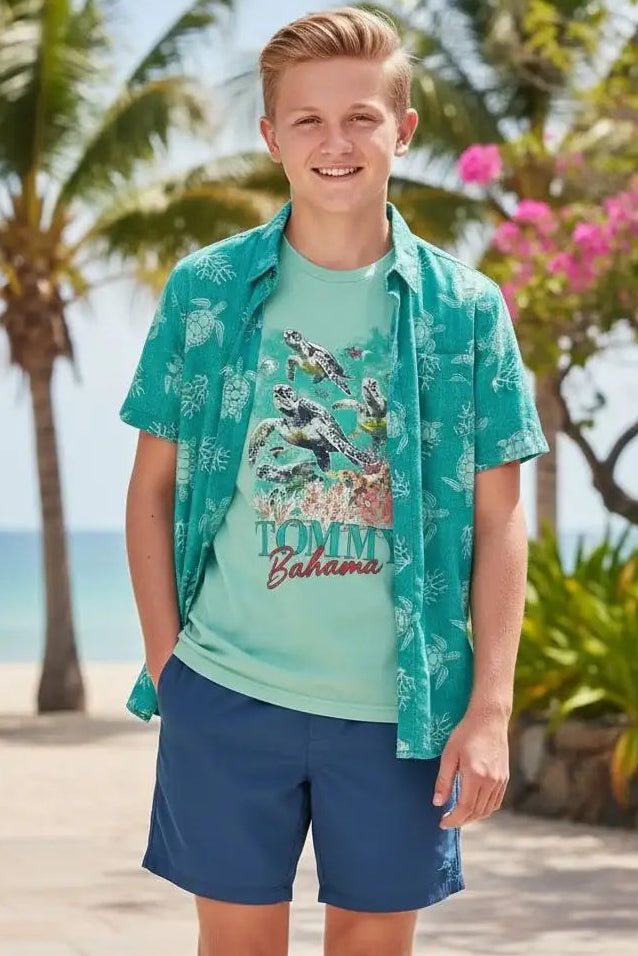 Young boy wearing a Tommy Bahama shirt on a tropical beach