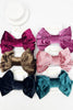 Set of colorful velvet hair bows on a white background