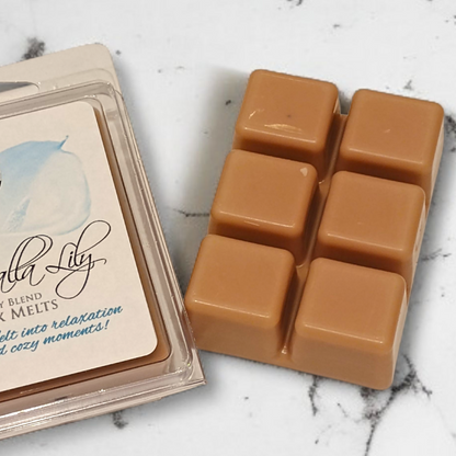 Caramel-colored wax melts in a clear plastic packaging on a marble surface