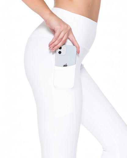 Person wearing white leggings with a phone in the pocket on a white background