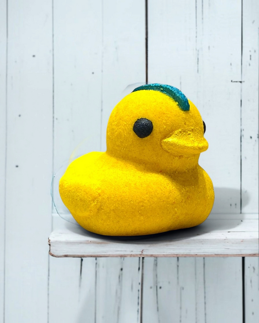 Yellow rubber duck with a blue mohawk on a white wooden shelf