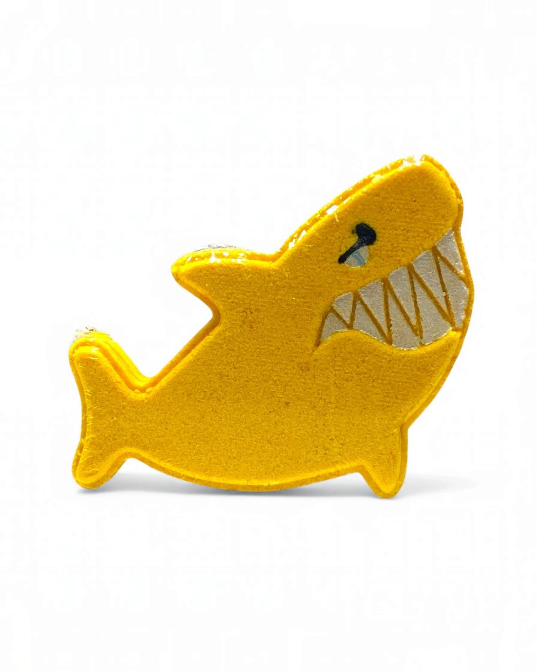 Yellow shark-shaped toy on a white background
