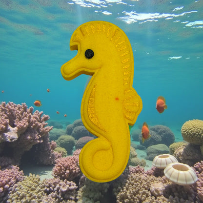 Yellow seahorse toy in an underwater scene with coral and fish