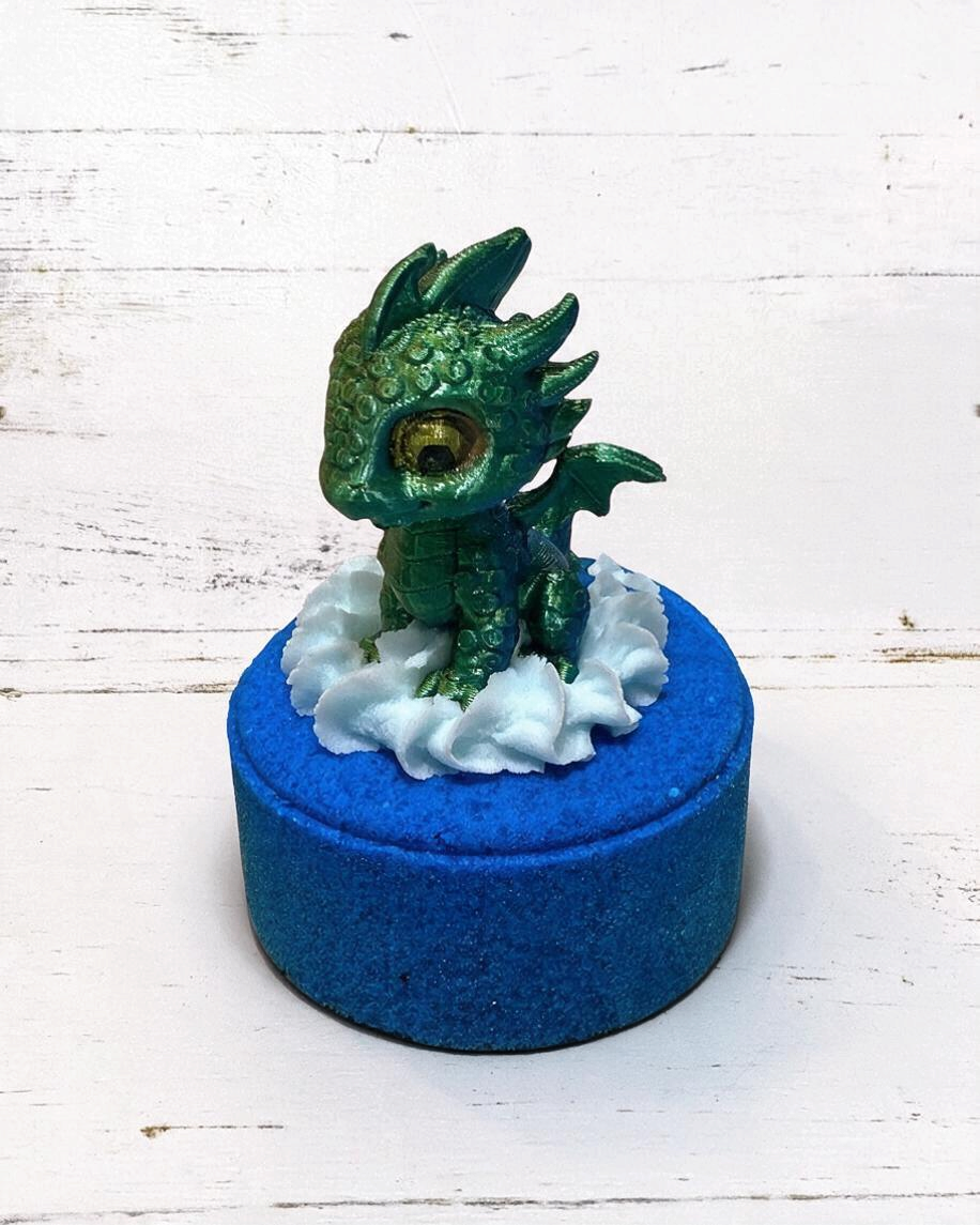 Calla Lily Cosmetics + CL kids Water Dragon bath bomb with a green 3D printed dragon toy and blue blueberry scent