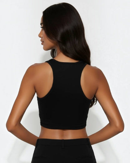 Woman wearing a black sleeveless top against a white background