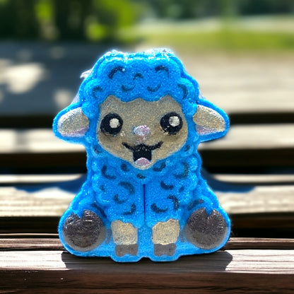 Blue plush toy with a smiling face on a wooden bench