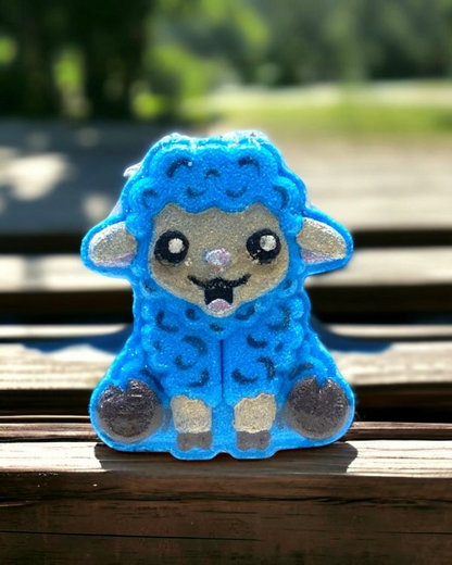 Blue plush toy with a smiling face on a wooden bench