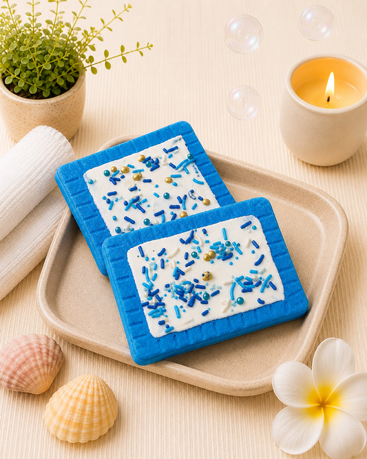 Two blue coasters with white centers and blue sprinkles on a beige tray, surrounded by decorative items.