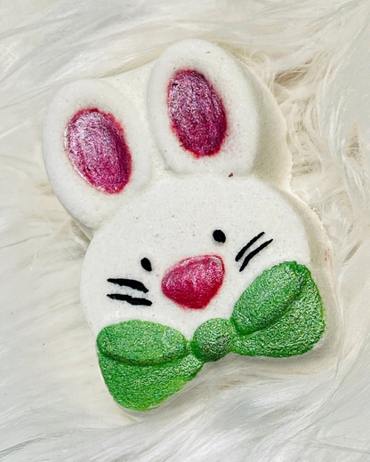 Calla Lily Cosmetics + CL kids white bunny bath bomb with pink ears, pink nose, and a sparkly green bow tie.