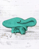 Calla Lily Cosmetics + CL kids teal brontosaurus shaped bath bomb with floral scent on a white wooden background