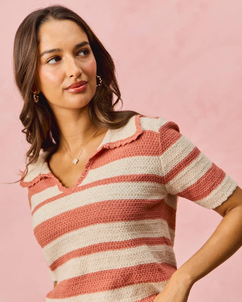 Woman wearing a striped pink and white shirt against a pink background