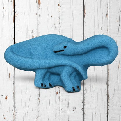 Calla Lily Cosmetics + CL kids blue brontosaurus shaped bath bomb with blood orange scent on white wood background