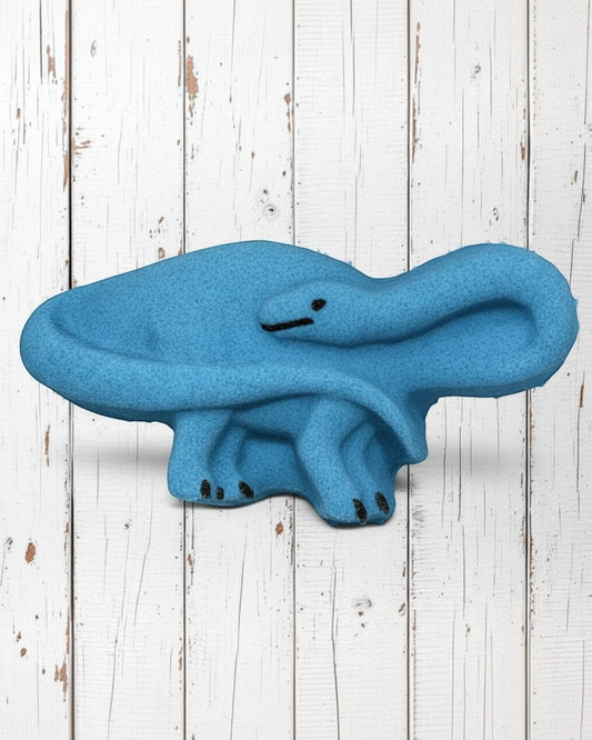 Calla Lily Cosmetics + CL kids blue brontosaurus shaped bath bomb with blood orange scent on white wood background