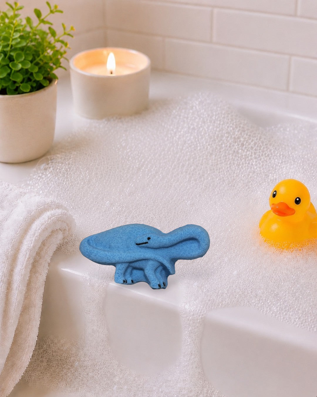 Calla Lily Cosmetics + CL kids blue brontosaurus shaped bath bomb with blood orange scent for kids.