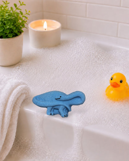 Calla Lily Cosmetics + CL kids blue brontosaurus shaped bath bomb with blood orange scent for kids.