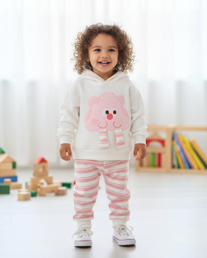 Toddler wearing a Calla Lily Cosmetics + CL kids white hoodie with a pink cartoon character and striped joggers.