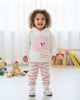 Toddler wearing a Calla Lily Cosmetics + CL kids white hoodie with a pink cartoon character and striped joggers.